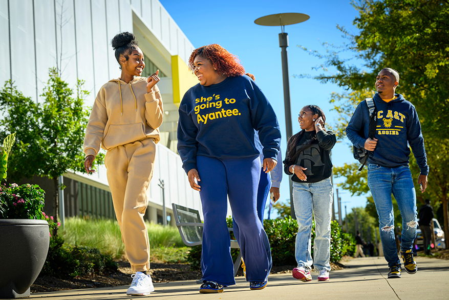 four students socializing on campus