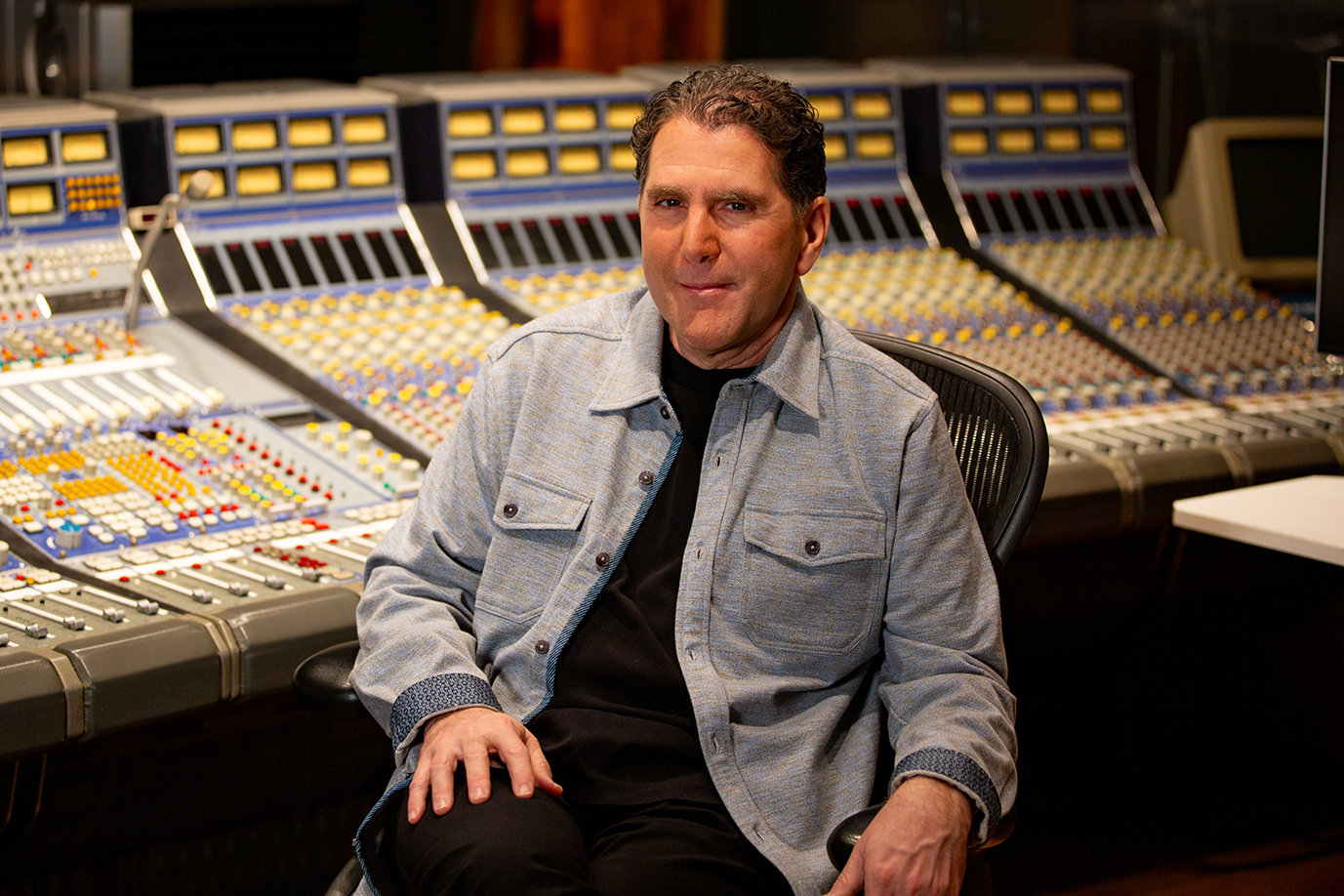 Dr. Nolan Gasser sitting in music production studio.